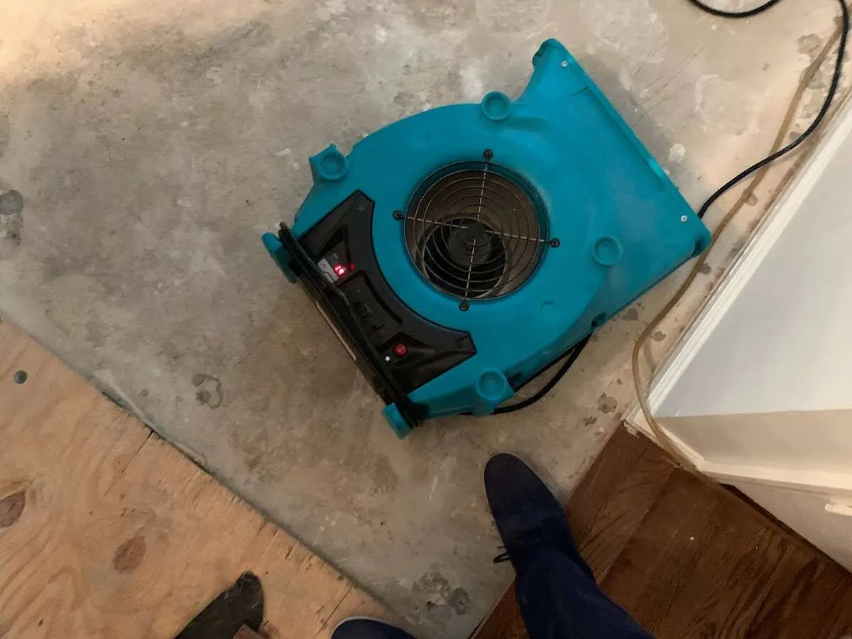 Air mover drying subfloor during Leak Detection & Repair in Tupper Lake